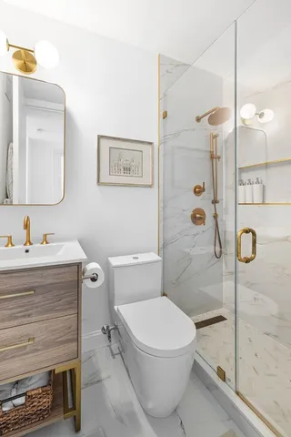 a bathroom with a toilet sink and mirror