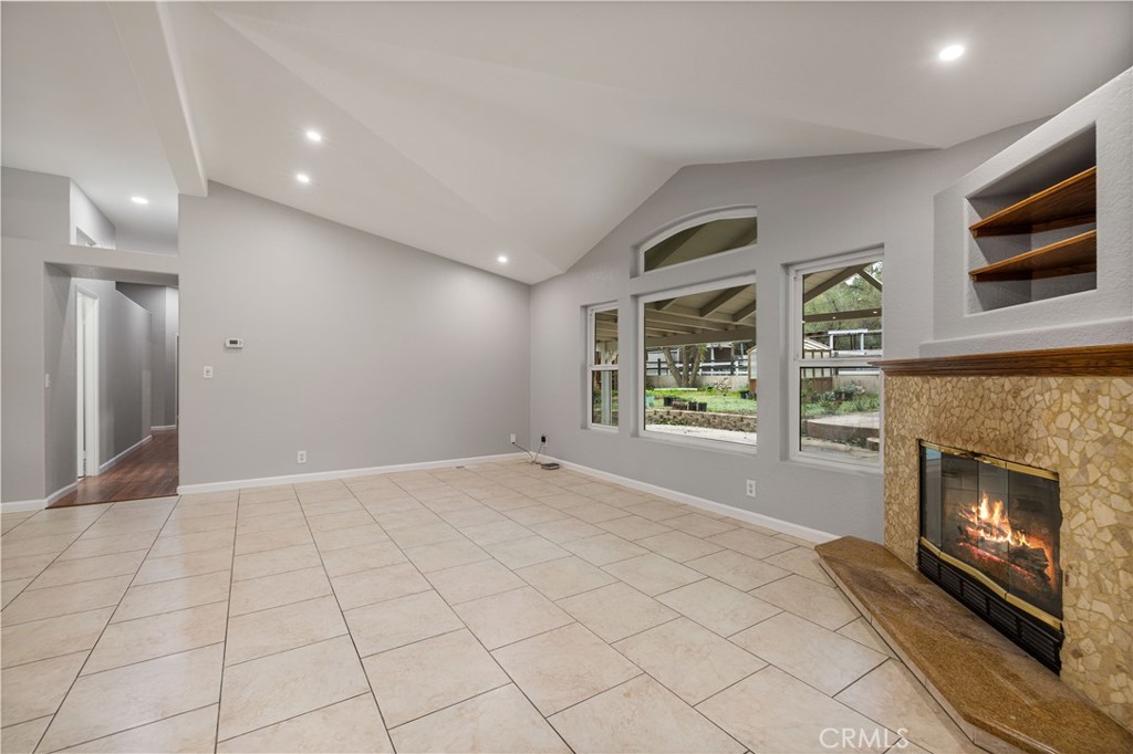 15608 Tierra Rejada Road Moorpark, CA 93021 - Photo 11 of 34 a view of an empty room with a fireplace and a window