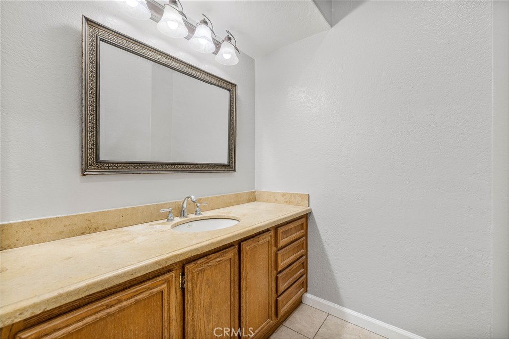 15608 Tierra Rejada Road Moorpark, CA 93021 - Photo 14 of 34 a utility room with a sink a mirror and vanity