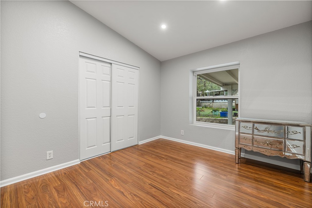 15608 Tierra Rejada Road Moorpark, CA 93021 - Photo 18 of 34 an empty room with wooden floor and windows