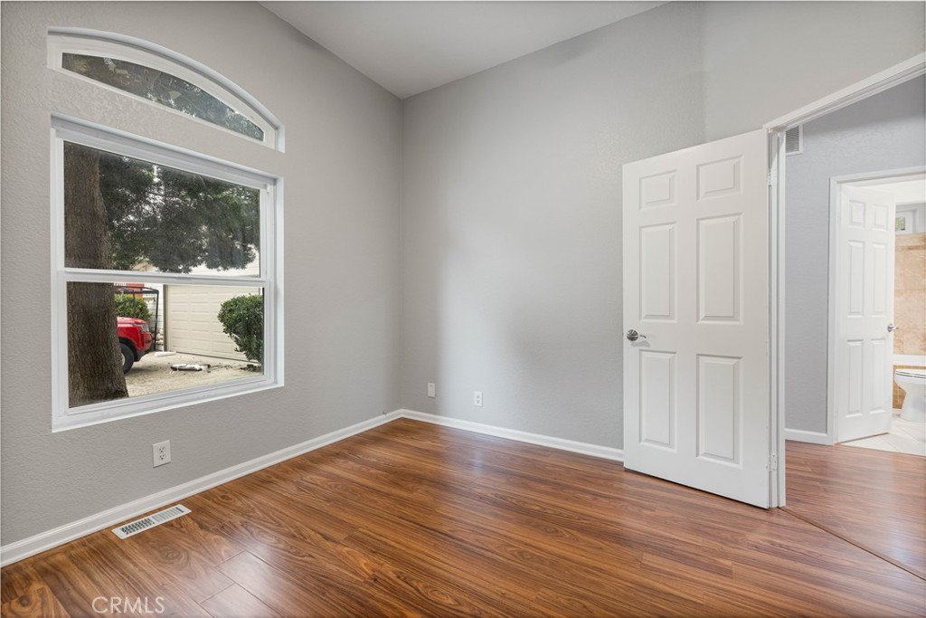 15608 Tierra Rejada Road Moorpark, CA 93021 - Photo 20 of 34 a view of an empty room with wooden floor and a window