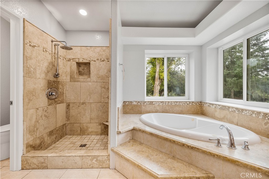 15608 Tierra Rejada Road Moorpark, CA 93021 - Photo 23 of 34 a bathroom with a bathtub and a shower