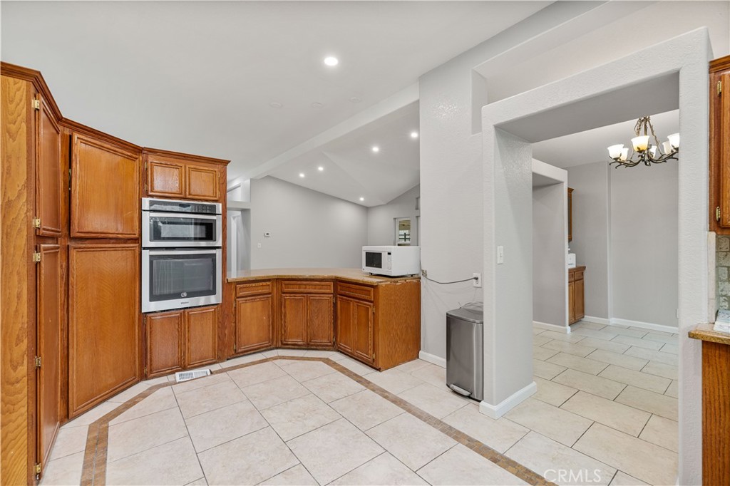 15608 Tierra Rejada Road Moorpark, CA 93021 - Photo 7 of 34 a kitchen with stainless steel appliances granite countertop a refrigerator and a sink