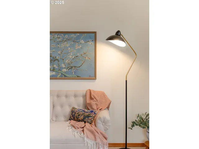 a living room with furniture and flowers