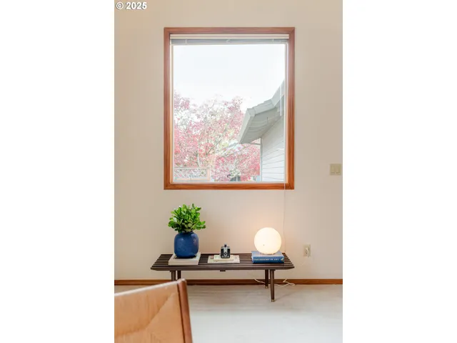 a view of a hallway with couches and dining table