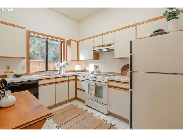 a kitchen with a sink stove and cabinets