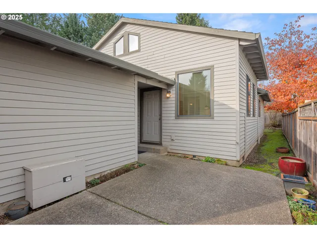 a view of a house with a yard and wooden fence
