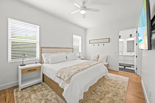 a bedroom with a bed and a chandelier