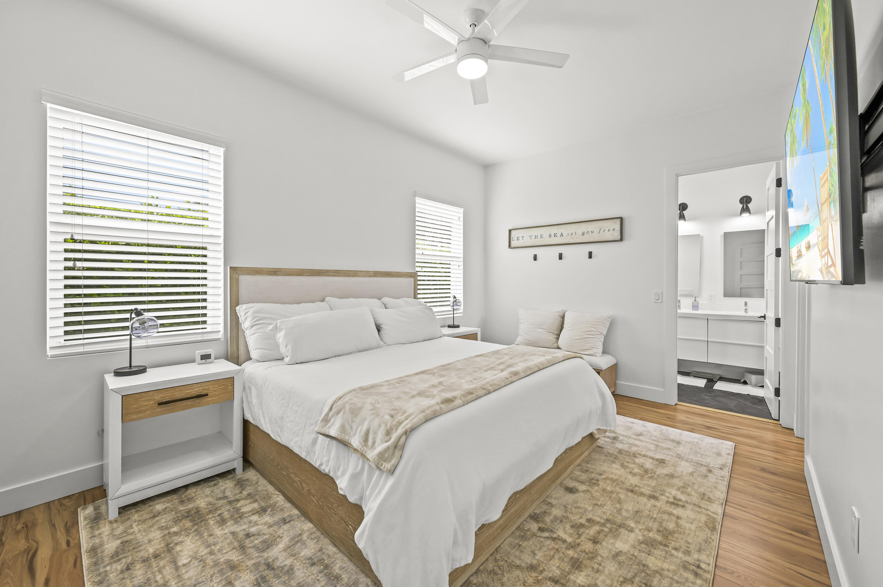68 Azalea Circle Tequesta, FL 33469 - Photo 13 of 36 a bedroom with a bed and a chandelier