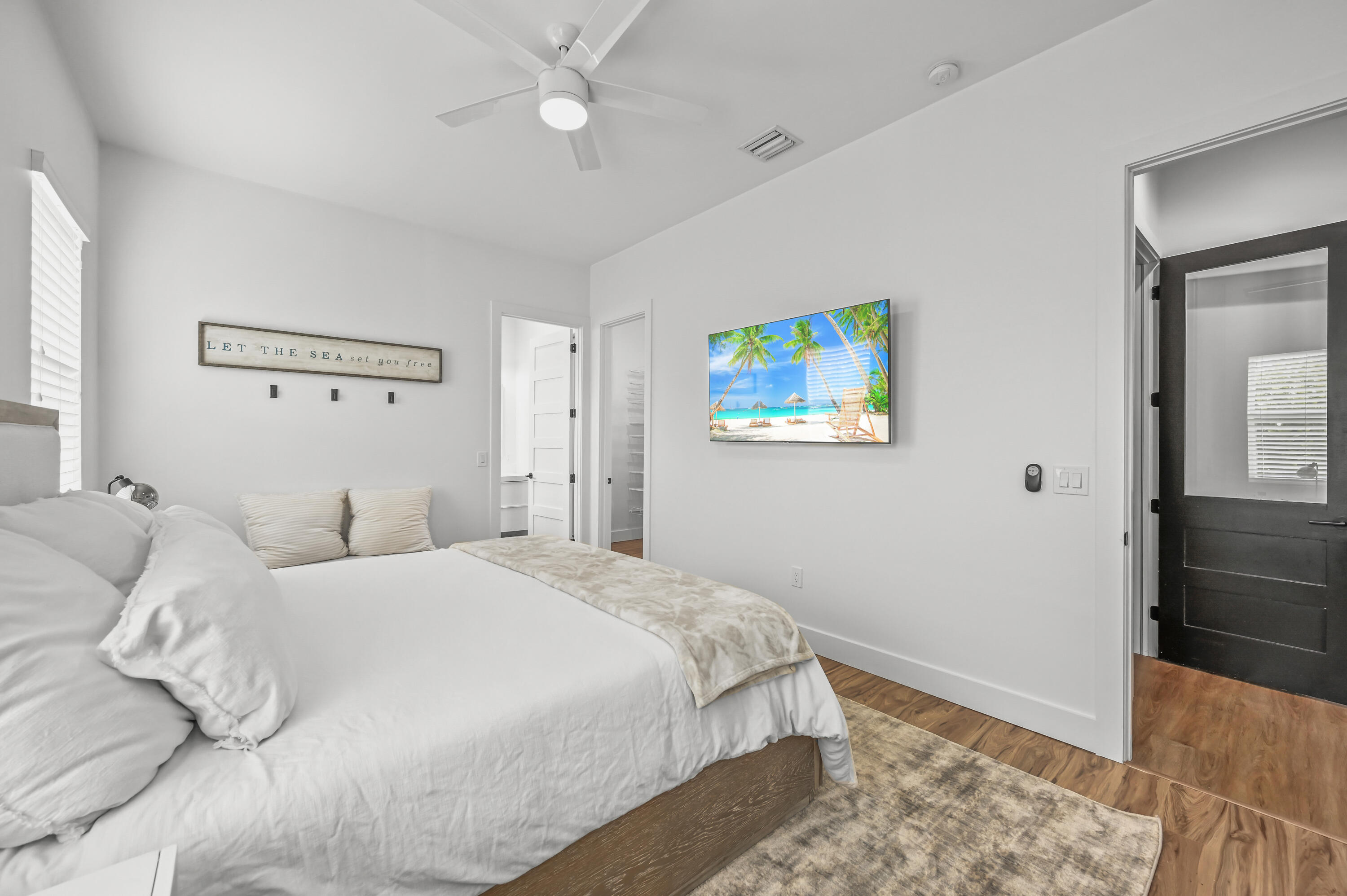 68 Azalea Circle Tequesta, FL 33469 - Photo 15 of 36 a bedroom with a bed and a painting on the wall