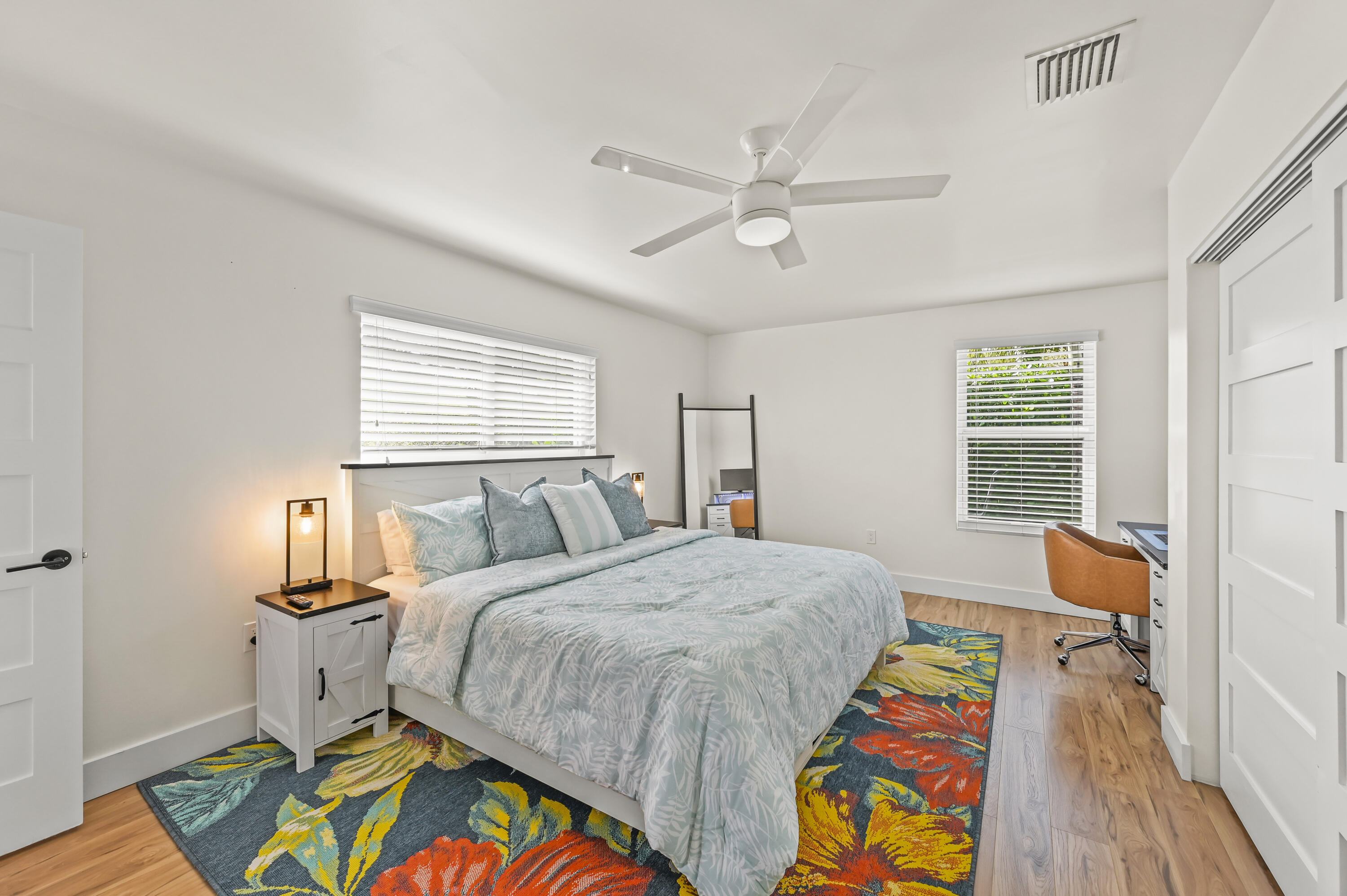 68 Azalea Circle Tequesta, FL 33469 - Photo 21 of 36 a bedroom with a bed and wooden floor
