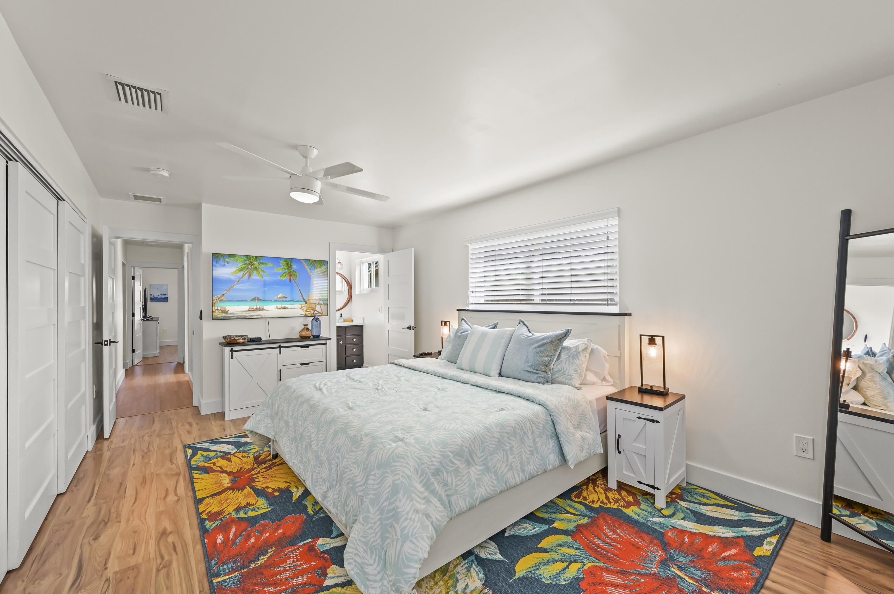 68 Azalea Circle Tequesta, FL 33469 - Photo 23 of 36 a bedroom with a bed and a table