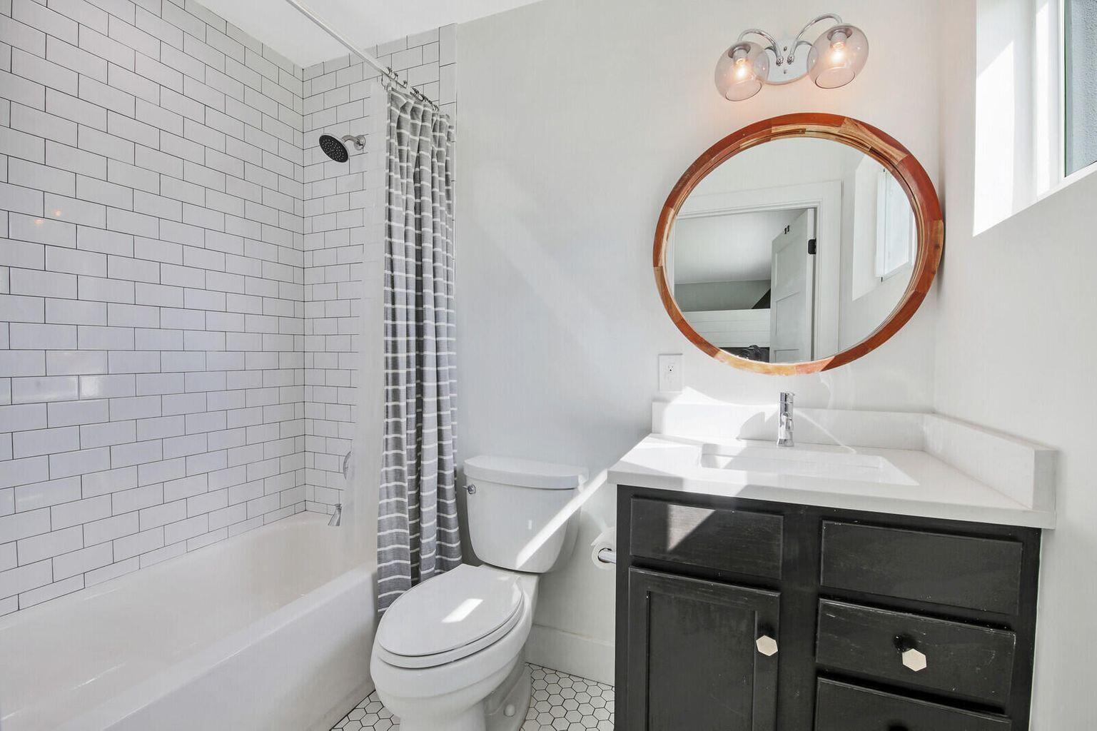 68 Azalea Circle Tequesta, FL 33469 - Photo 24 of 36 a bathroom with a sink a toilet and a mirror