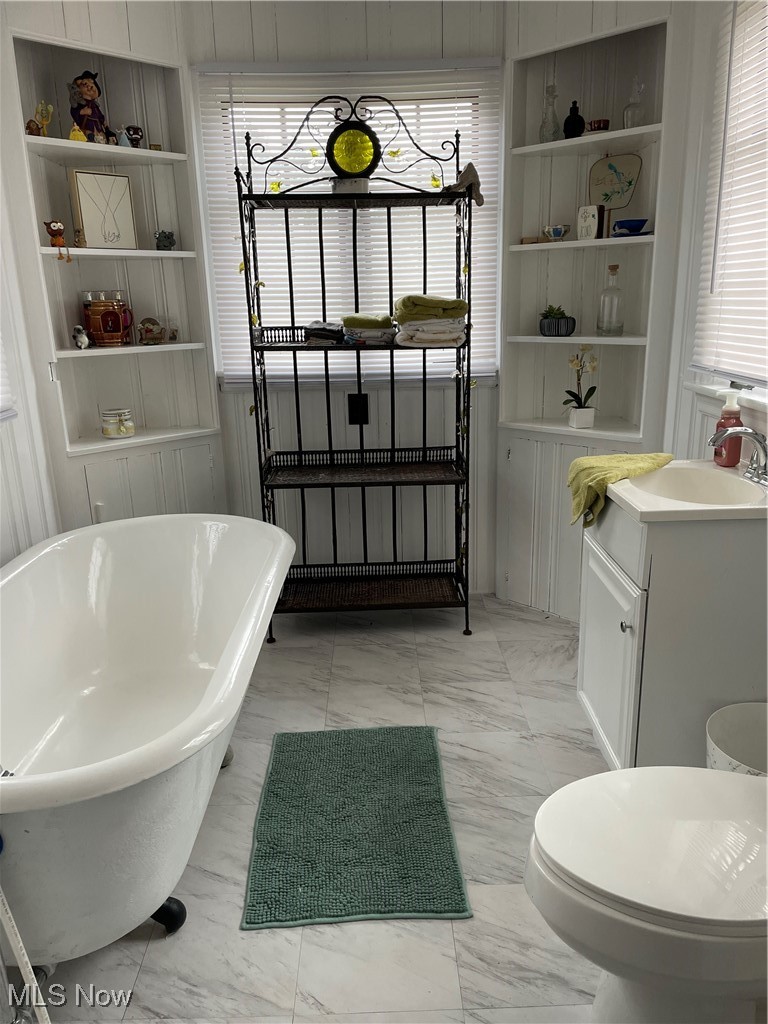 5313 Reed Avenue Ashtabula, OH 44004 - Photo 9 of 18 Bathroom with built in shelves, a tub, toilet, and vanity