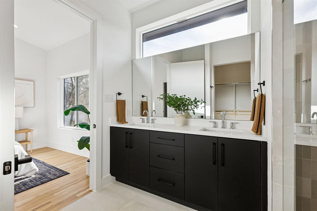 2142 Lovedale Avenue, Unit 104 Dallas, TX 75235 - Photo 21 of 29 a en suite bathroom with a granite countertop sink and a mirror
