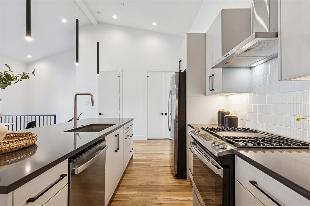 2142 Lovedale Avenue, Unit 104 Dallas, TX 75235 - Photo 8 of 29 a kitchen with kitchen island a sink appliances and cabinets
