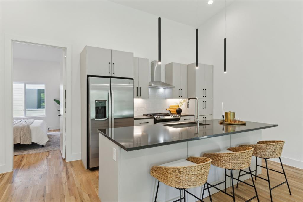 2142 Lovedale Avenue, Unit 104 Dallas, TX 75235 - Photo 9 of 29 a kitchen with stainless steel appliances granite countertop a sink refrigerator and cabinets