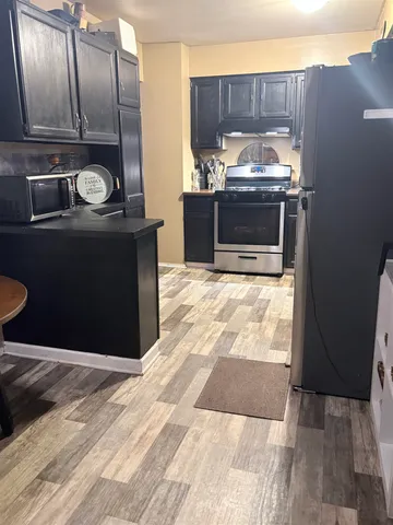 a kitchen with granite countertop a stove and a refrigerator