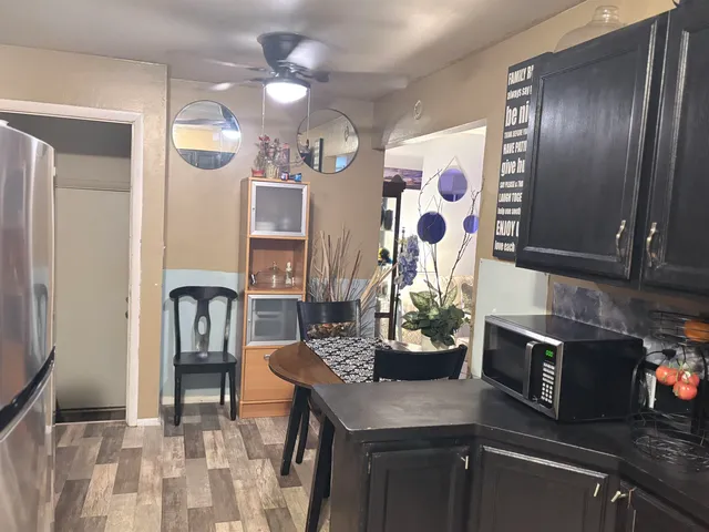 a kitchen with stainless steel appliances granite countertop a sink a stove and a refrigerator