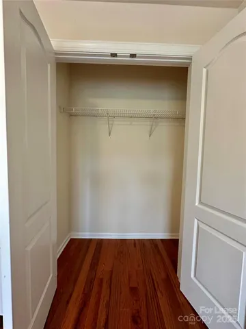 a view of storage and utility room with wooden floor