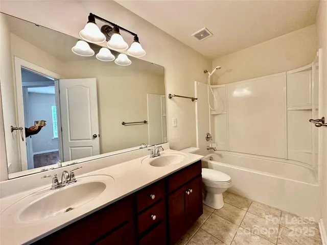 a bathroom with a double vanity sink and a mirror