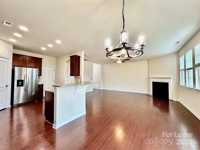 a view of a kitchen with sink and wooden floor