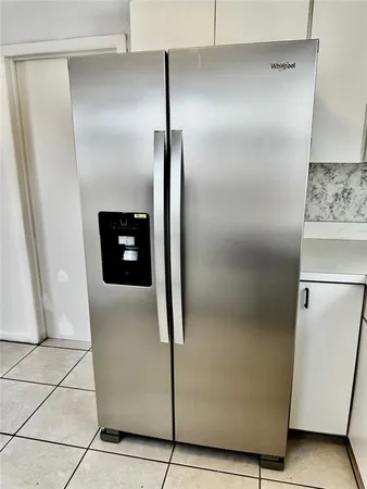 a refrigerator freezer sitting inside of a kitchen