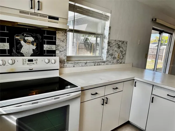 a stove top oven sitting inside of a kitchen