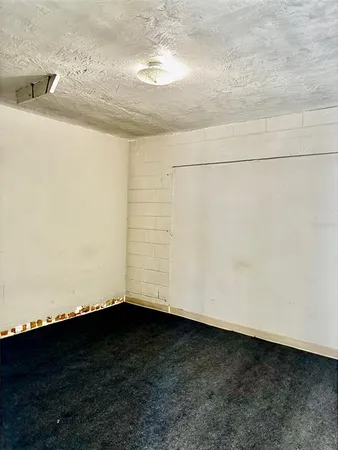 a view of wooden floor and brick wall
