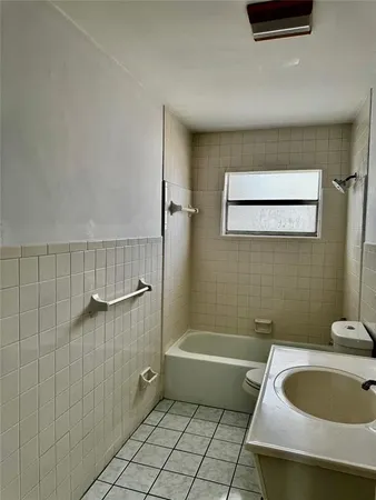 a bath room with a toilet and a bath tub