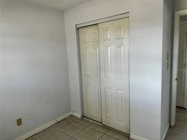 an empty room with closet area