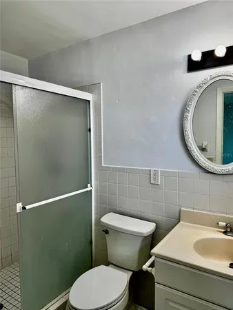 a bathroom with a sink a toilet and a mirror