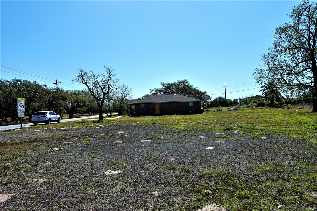 627 8th Street Ingleside, TX 78362 - Photo 7 of 14 a view of a outdoor space with deck and trees