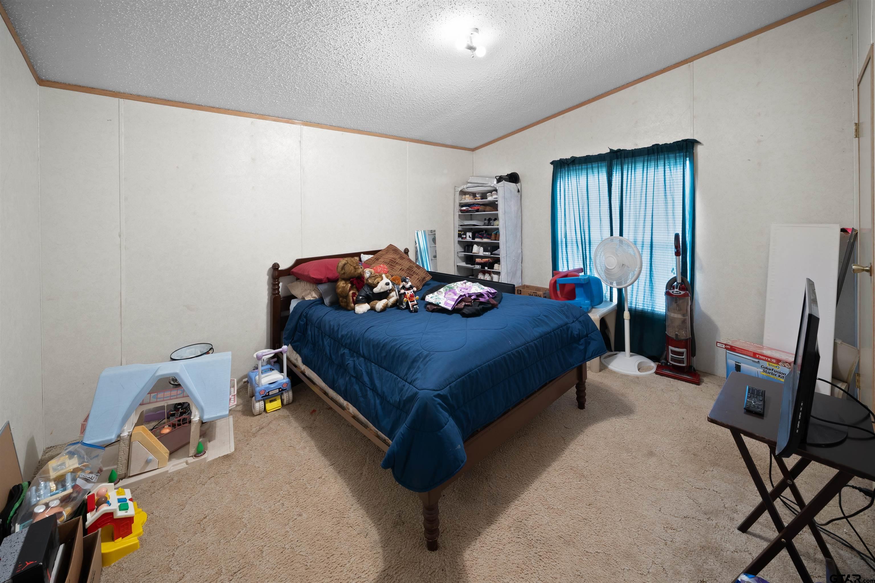 2425 Thompson Lane Tyler, TX 75704 - Photo 17 of 27 a bedroom with a bed and a window