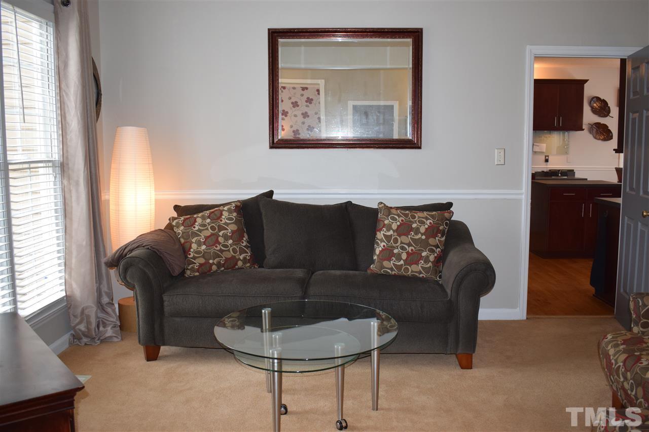 5200 Calverton Drive Raleigh, NC 27613 - Photo 11 of 25 Dining room with access to kitchen is currently being as a living room.