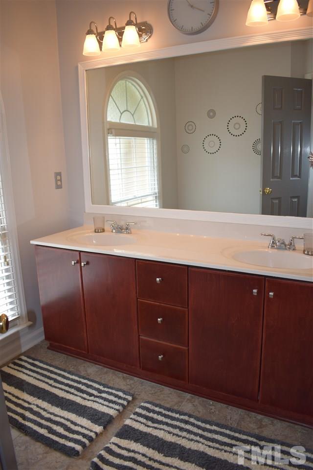 5200 Calverton Drive Raleigh, NC 27613 - Photo 20 of 25 Secondary bathroom has dual vanity sink & separate room with tub/shower.