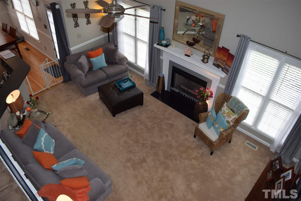 5200 Calverton Drive Raleigh, NC 27613 - Photo 6 of 25 Large family room opens to the kitchen with cathedral ceiling, skylights, gas log fireplace, ceiling fan & chair rail.