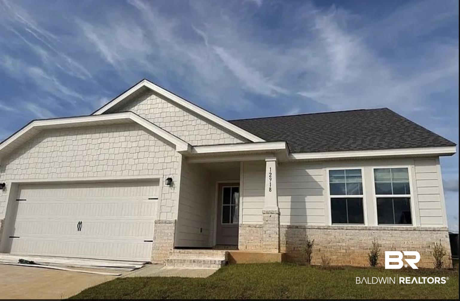 12918 Flanagan Street Elberta, AL 36530 - Photo 32 of 33 Contemporary facade featuring mixed siding, a columned entryway, a dark shingle roof, double-paned windows, and an integrated two-car garage