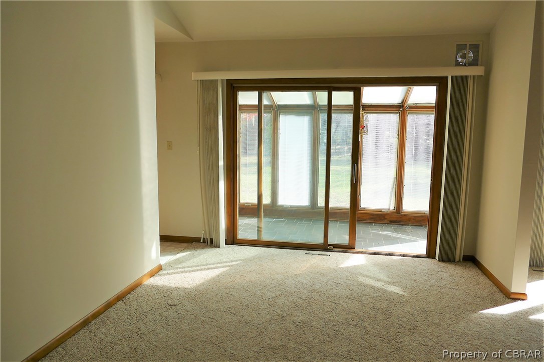 895 Holly Point Road Mathews, VA 23109 - Photo 18 of 47 a view of empty room with floor to ceiling window