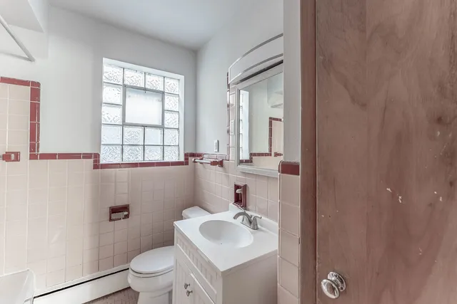 a bathroom with a sink toilet and mirror