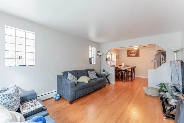 a living room with furniture and wooden floor
