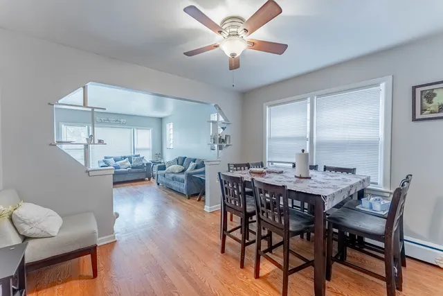 a view of a dining room with furniture and wooden floor