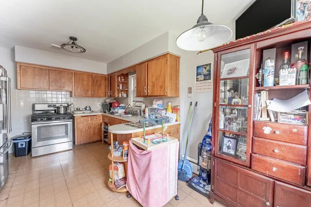 a kitchen with stainless steel appliances granite countertop a stove refrigerator and cabinets