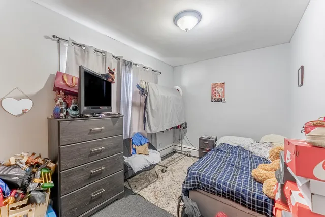 a bedroom with a bed and flat screen tv