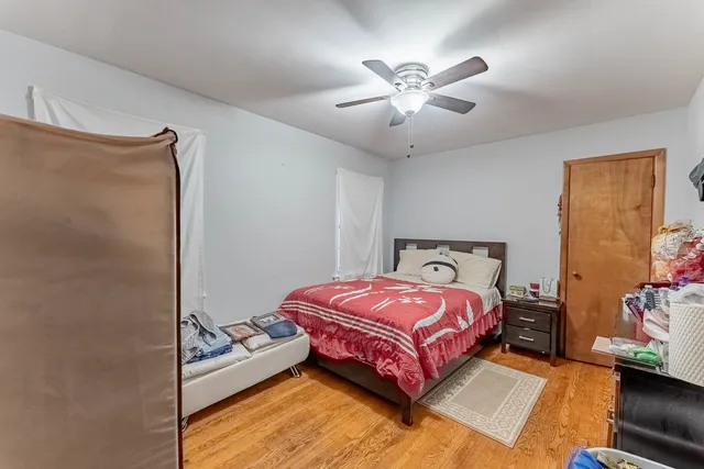a bedroom with a bed and a chandelier