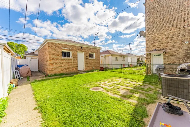 a backyard of a house with table and chairs