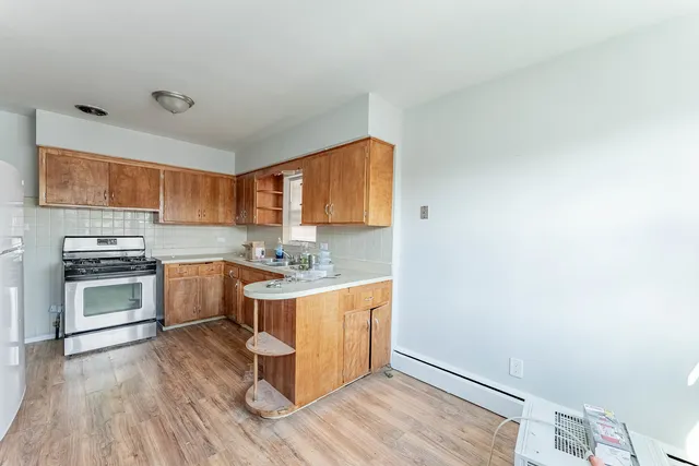 a kitchen with granite countertop a stove top oven and sink