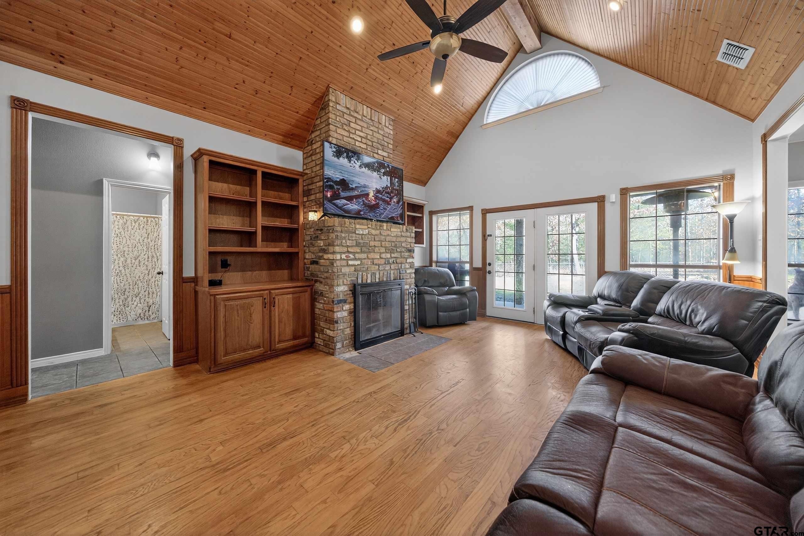 781 Highway 19 Edgewood, TX 75117 - Photo 11 of 48 a living room with couches and kitchen view with wooden floor