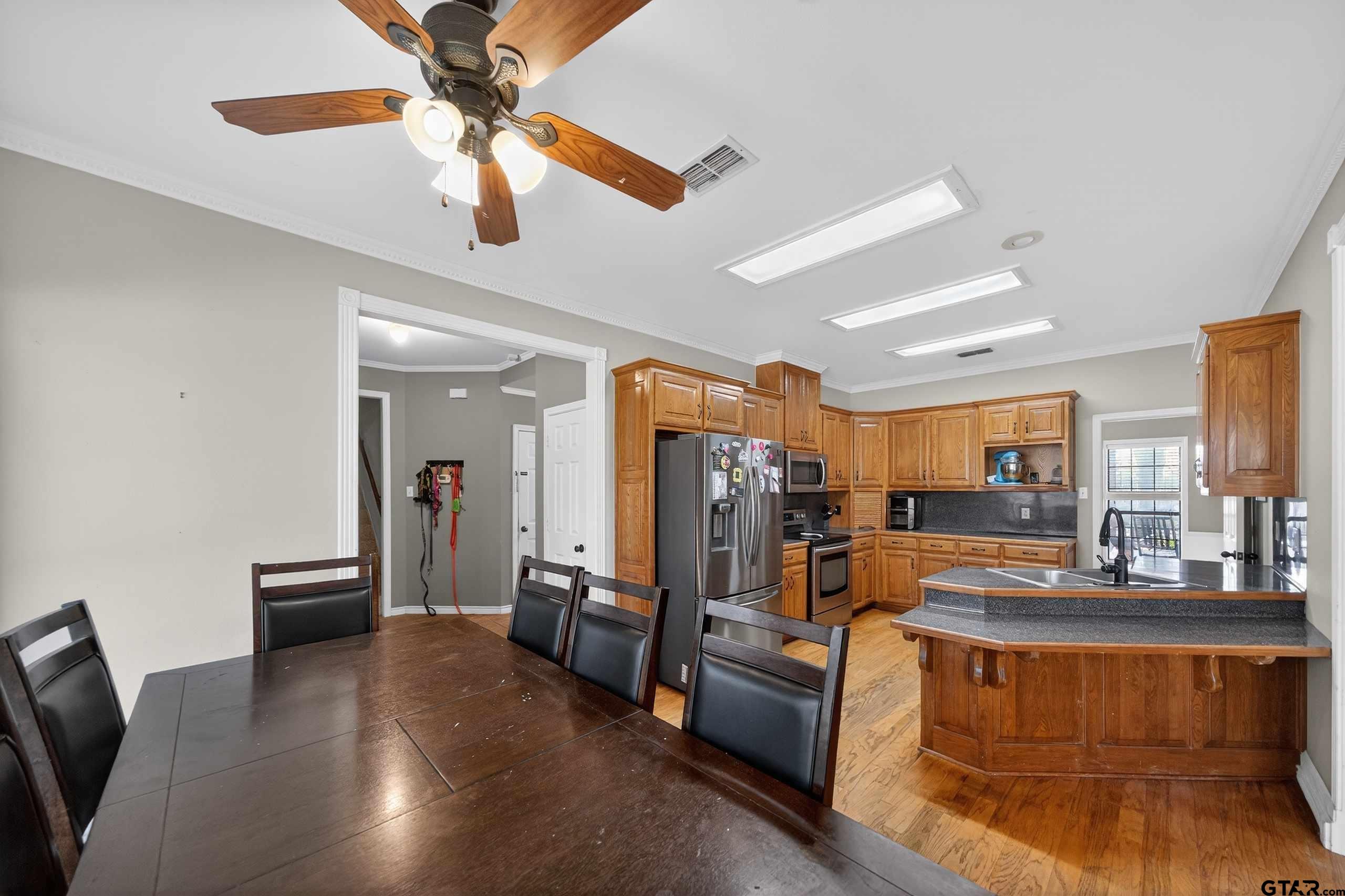 781 Highway 19 Edgewood, TX 75117 - Photo 16 of 48 a view of a livingroom with furniture a ceiling fan and wooden floor