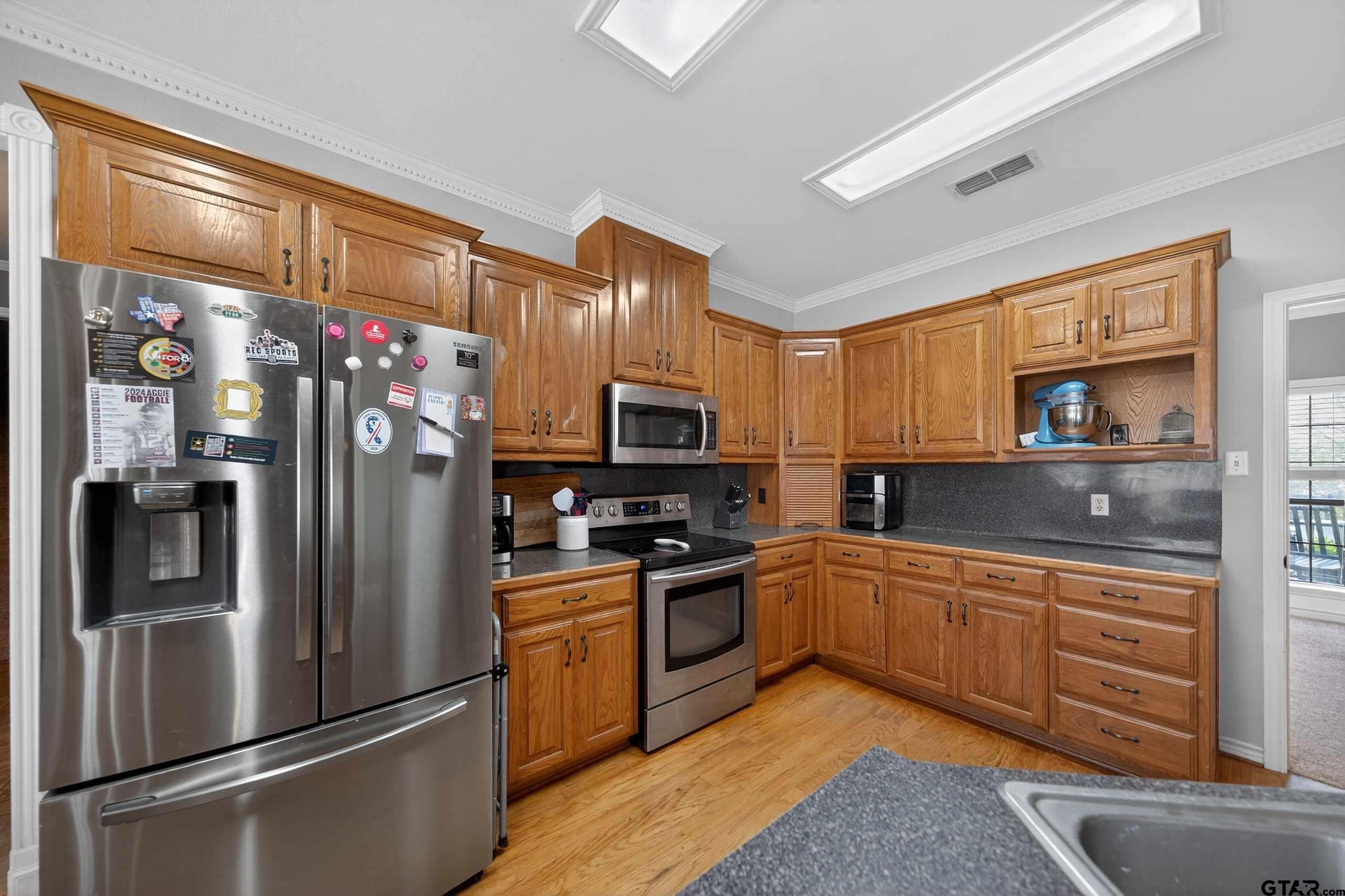 781 Highway 19 Edgewood, TX 75117 - Photo 18 of 48 a kitchen with stainless steel appliances granite countertop a refrigerator and a sink